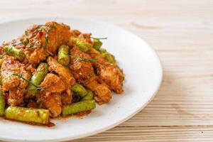 Stir fried pork and red curry paste with sting bean photo