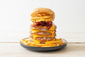 Pork hamburger or pork burger with cheese, bacon, and french fries photo