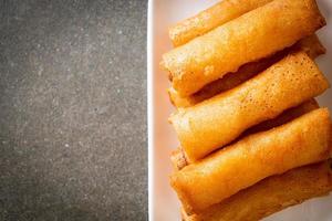 Deep-fried spring roll with sauce on white plate photo