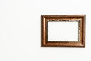 Empty picture frame on white wall background with copy space photo