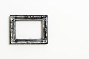 Empty picture frame on white wall background with copy space photo