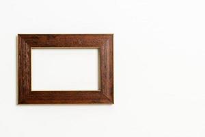 Empty picture frame on white wall background with copy space photo