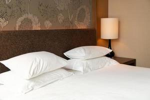 White pillow decoration on bed in hotel resort bedroom photo