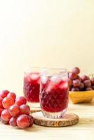 Fresh grape juice on wood background photo