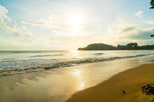 Beautiful and empty beach sea at sunrise or sunset time photo