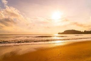 Beautiful and empty beach sea at sunrise or sunset time photo