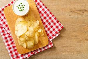 Potato chips with sour cream dipping sauce photo