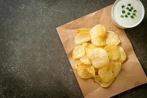 Potato chips with sour cream dipping sauce photo