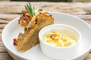 Banana cake with cream cheese and crumble on plate photo