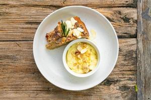 Banana cake with cream cheese and crumble on plate photo