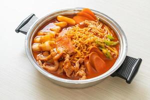 Budae Jjigae or Budaejjigae, or Army stew or Army base stew. It is loaded with Kimchi, spam, sausages, ramen noodles and much more - popular Korean hot pot food style photo