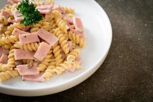 Spirali or spiral pasta mushroom cream sauce with ham - Italian food style photo