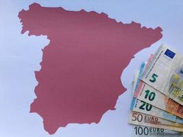 Billetes europeos y fondo con silueta de mapa de España foto