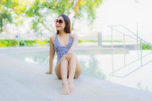 Beautiful young asian women happy smile relax around outdoor swimming pool in hotel resort for travel in holiday vacation photo