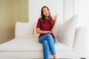 Portrait beautiful young asian women happy smile sit on sofa photo