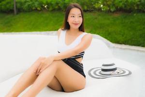 Portrait beautiful young asian women happy smile relax around swimming pool photo