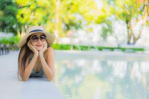 Beautiful young asian women happy smile relax around outdoor swimming pool in hotel resort for travel in holiday vacation photo