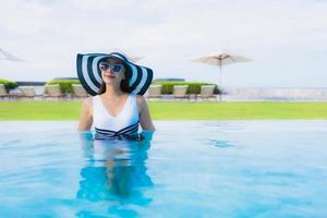 Portrait beautiful young asian women happy smile relax around swimming pool photo