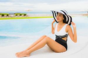 Portrait beautiful young asian women happy smile relax around swimming pool photo