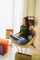Portrait beautiful young asian women using computer laptop or smart and mobile phone with credit card for online shopping photo