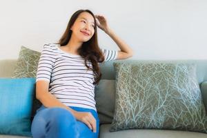 Portrait beautiful young asian woman smile happy on sofa photo