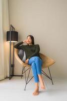 Portrait beautiful young asian women happy smile relax sitting on sofa chair photo