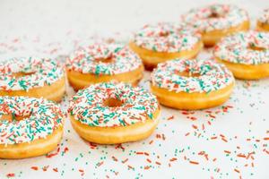 Donuts with white chocolate cream and sprinkles sugar photo