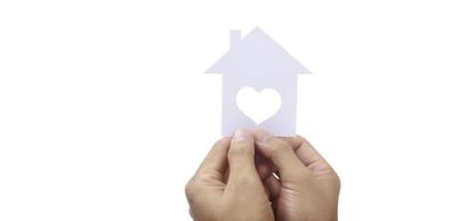 Hands holding paper house, family home  protecting insurance concept photo