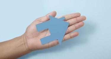 Hands holding paper house, family home  protecting insurance concept photo