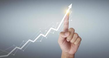 Hand touching  graphs of financial indicator  market analysis chart photo