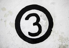 Number three on a white wall photo