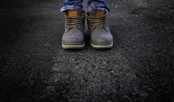 Men's boots in a forest photo