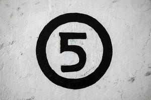 Number five on a white wall photo