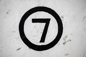 Number seven on a white wall photo