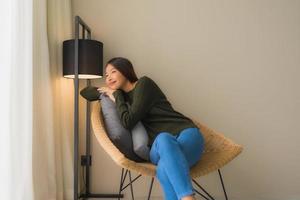 Portrait beautiful young asian women happy smile relax sitting on sofa chair photo