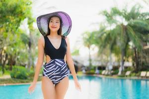 Portrait beautiful young asian women happy smile relax around swimming pool photo