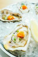 Raw and fresh oyster shell with lemon photo
