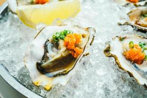 Raw and fresh oyster shell with lemon photo