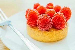 Sweet dessert custard tart with raspberry on top photo