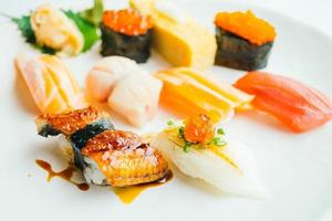 Raw and fresh nigiri sushi set in white plate photo