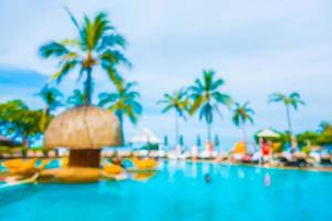 Abstract blur coconut palm tree around swimming pool photo