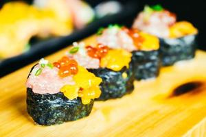 Uni sushi with otoro tuna and salmon egg on top photo