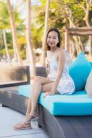 Portrait beautiful young asian woman happy smile relax around neary beach and sea photo