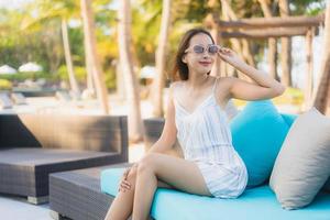 Portrait beautiful young asian woman happy smile relax around neary beach and sea photo