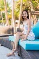 Portrait beautiful young asian woman happy smile relax around neary beach and sea photo
