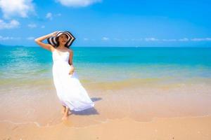 Portrait beautiful young asian woman happy smile leisure on the beach sea and ocean photo