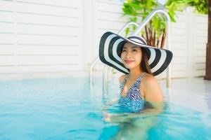 Portrait beautiful young asian woman happy smile relax around outdoor swimming pool photo