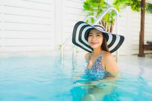 Portrait beautiful young asian woman happy smile relax around outdoor swimming pool photo