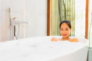 Portrait young beautiful asian woman take a bath in bathtub photo