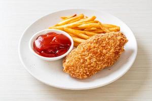 Fried chicken breast fillet steak with French fries and ketchup photo